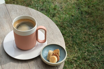 Coffee and cookies on a wooden table in the garden