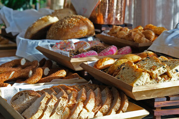 Open buffet area with various cheese, appetizers, meat and pastries for breakfast