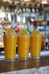 Freshly squeezed orange juices on marble counter indoors