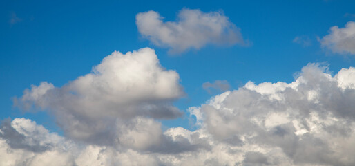 Beautiful bright blue sky with fluffy white clouds.