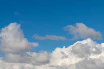 Beautiful bright blue sky with fluffy white clouds.
