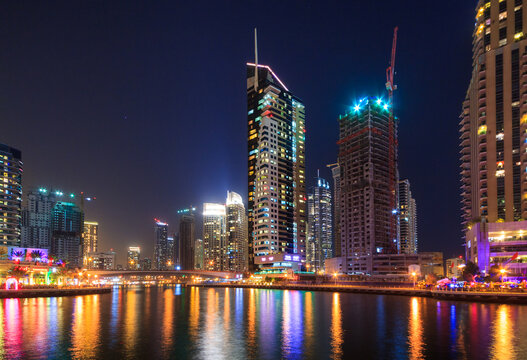 Dubai, UAE - March 31, 2014: Amazing architecture of the skyscrapers at Dubai Marina by night, UAE. 
