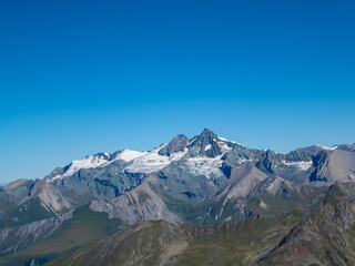 Panoramic view of majestic mountain peak Grossglockner seen from Hochschober, Schober Group, High Tauern, East Tyrol, Austria. Wanderlust Austrian Alps in summer. Rugged ridges against clear blue sky