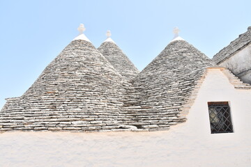 Fototapeta na wymiar Ancient stone house in Italy - Trulli of Alberobello, typical Apulian ancient construction