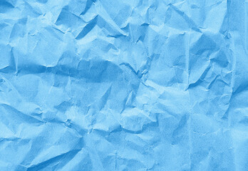 close up texture of light blue crumpled or torn old craft paper use as background with blank space for design. creased recycle blue craft paper texture for scarpbook concept.