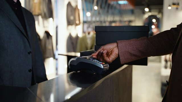 African American Man In Clothing Store Making Contactless Payment With Credit Card