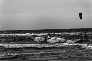 kite surfers ride the waves. Winter sport with high waves and many dangers. Wind and wave speed....