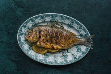 Delicious fried fish Dorado on plate