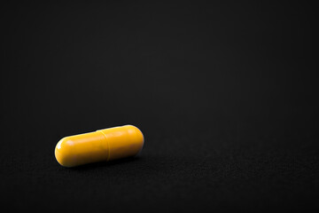 Medical pills. Color capsules medication. Black background. Health care concept. Free space for text. Medicines. Many different pills. Chemical industry.