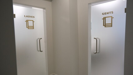 Men's and women's bathroom entrance in a business