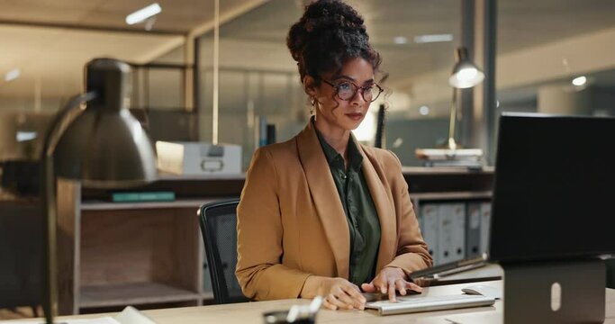 Business, night or woman with glasses on computer in office for startup research, planning or typing schedule. Working late, deadline or entrepreneur online for project, search or email communication