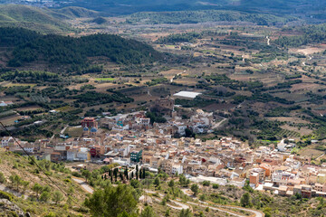 Fototapeta na wymiar aerial image of a small village surrounded by mountains and nature