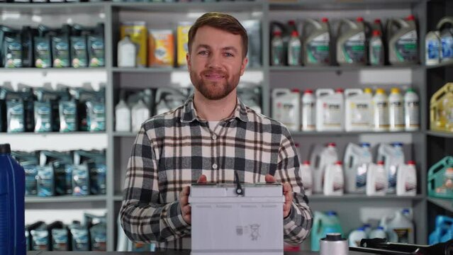 Salesman offers the best battery for car in an auto parts store