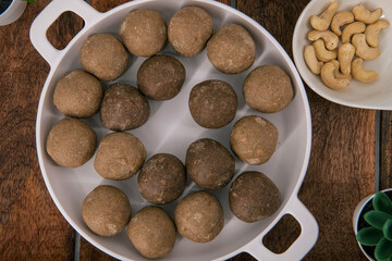 Fresh home made urad dal and millet laddu isolated and decorated. Locally called Urad Dal Ladoo, Ulundu urundan, Ulundu laddu, Kambu laddu. Selective focused millet ladoo.