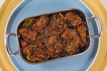 Sukha mutton or chicken, dry spicy Murgh or goat meat served hot,  mutton fry, special hot spicy traditional dish. Buffalo roast, meat pepper fry. Top view South Indian non veg food side dish Rice