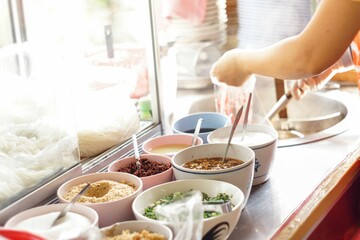 Chef cooking noodles at noodle shop,
Chef preparing food scene, Thailand street food, Asian Gourmet market concept