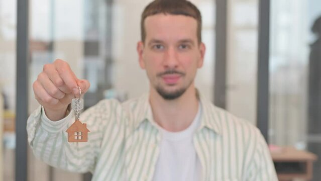 Portrait of Man Showing Home Keys