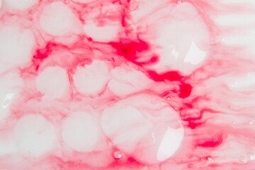 Pink white gel with drops and flowing gel. Background abstract flowing smooth
