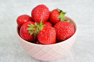 strawberries in pink bowl isolated close up