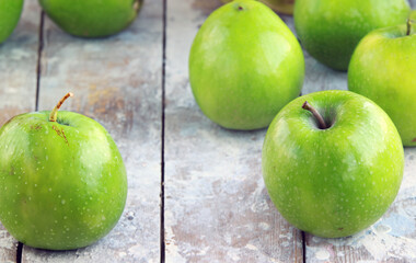 organic granny smith apples on wooden table