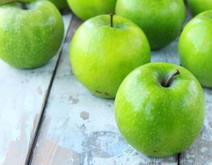 organic granny smith apples on wooden table