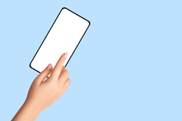 Female hand holding phone with blank screen on blue background