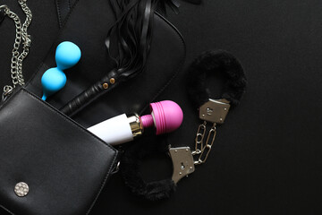 Sex toys. A small black bag with game handcuffs, vaginal balls, a vibrator and a leather whip for...
