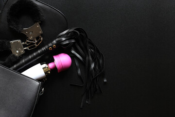 Sex toys. A small black bag with game handcuffs, vibrator and a leather whip for intimate games....