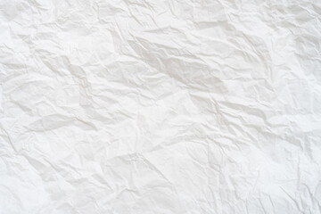 Wrinkled or crumpled white stencil paper or tissue paper after use with large copy space used for background texture