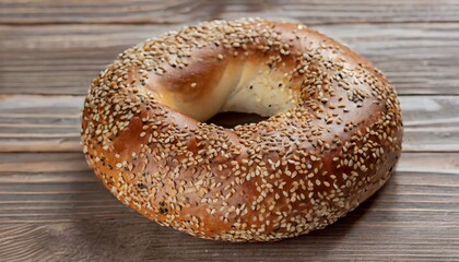 Bagel with sesame seeds on a wooden table.