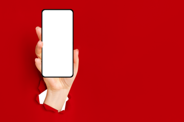 A hand with a phone and a blank screen breaks out of red torn paper.