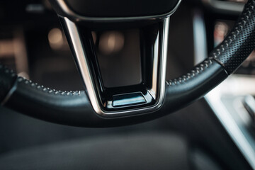 Modern car sport steering wheel close up - obrazy, fototapety, plakaty