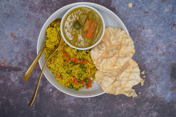 Rice pilaf with sambar- lentil and vegetables gravy, along with papad