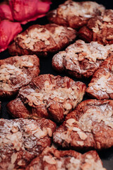 Sweet freshly baked croissants with almonds and powdered sugar. Delicious dessert