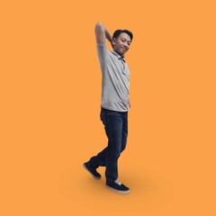 Fototapeta na wymiar Full length image of Handsome man in his 30s wearing a t-shirt and jeans laughing while standing isolated on an orange background