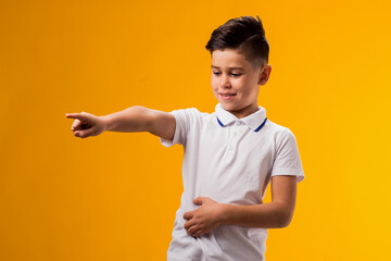 Kid boy mocking and teasing at someone showing finger at camera and holding stomach. Bulling concept