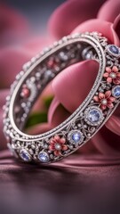 Jewelry ring with precious stones on a background of pink flowers