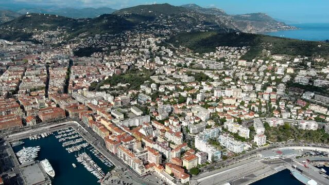 Beautiful aerial panoramic view city of Nice, Cote d'Azur, France. Luxury resort of French riviera high angle view of port, bay under blue sky and urban neighborhood on a summer day 4K