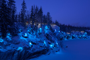 Blue illumination of the Marble Canyon on a January twilight. Ruskeala Mountain Park. Karelia, Russia