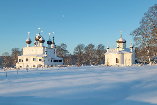 Ancient churches of the Epiphany and St. Alexander Nevsky in a winter landscape on a frosty January morning. Khopylevo. Yaroslavl region, Russia