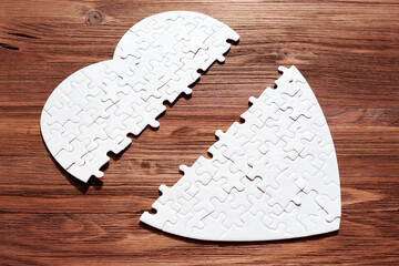 White Heart Shaped Puzzle Fragmented on Wood