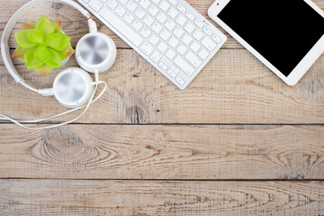 Wooden office table with computer, pen and a cup of coffee, lot of things. Top view with copy space.