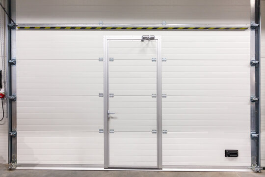 Industrial Garage Gate With White Roller Shutter Door and Integrated Pedestrian Access