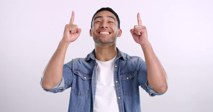 Man, pointing and face with choice in promotion and review with thumbs up in announcement mockup. Studio, space and person gesture yes for agreement, happiness and opinion of satisfaction for offer