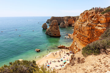 View to coastline with beautiful and sunny portuguese beach Praia da Marinha near Lagoa in summer, Algarve Portugal