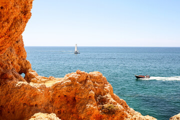 View to coastline with caves at Benagil near beautiful portuguese beach Praia de Carvoeiro near Lagoa in summer, Algarve Portugal