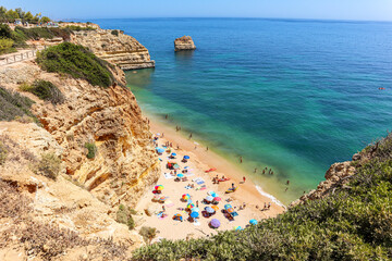 View to coastline with beautiful and sunny portuguese beach Praia da Marinha near Lagoa in summer, Algarve Portugal
