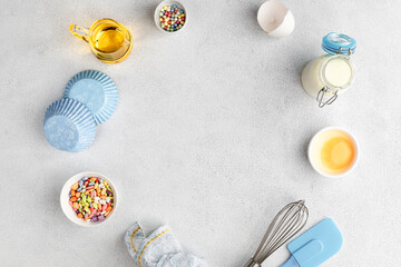 Baking ingredients: flour, eggs, yolk, on a white table.