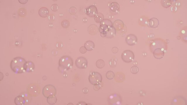Soap bubbles on a pink background