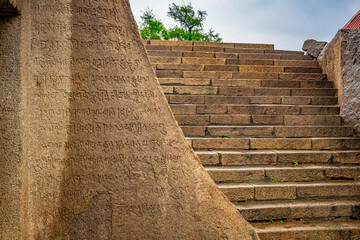 An Ancient Tamil Letters Inscription or Vattezhuthu or grantha script at near Tiger Cave is a...